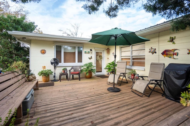 wooden deck featuring a grill