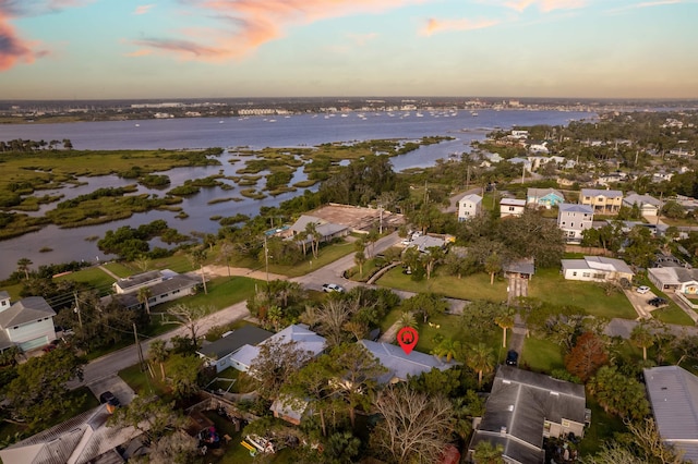 aerial view at dusk with a water view