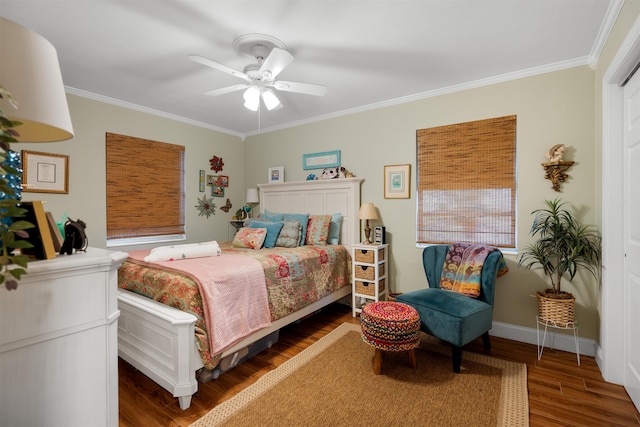 bedroom with dark hardwood / wood-style floors, ceiling fan, and crown molding