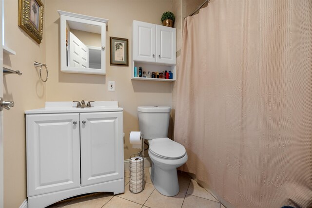 bathroom featuring toilet, vanity, and tile patterned floors