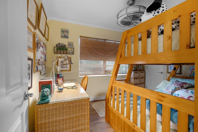 bedroom with light hardwood / wood-style floors and ornamental molding