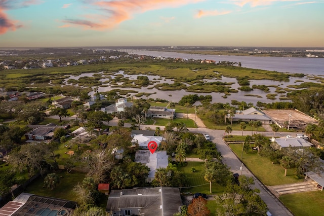 aerial view at dusk with a water view