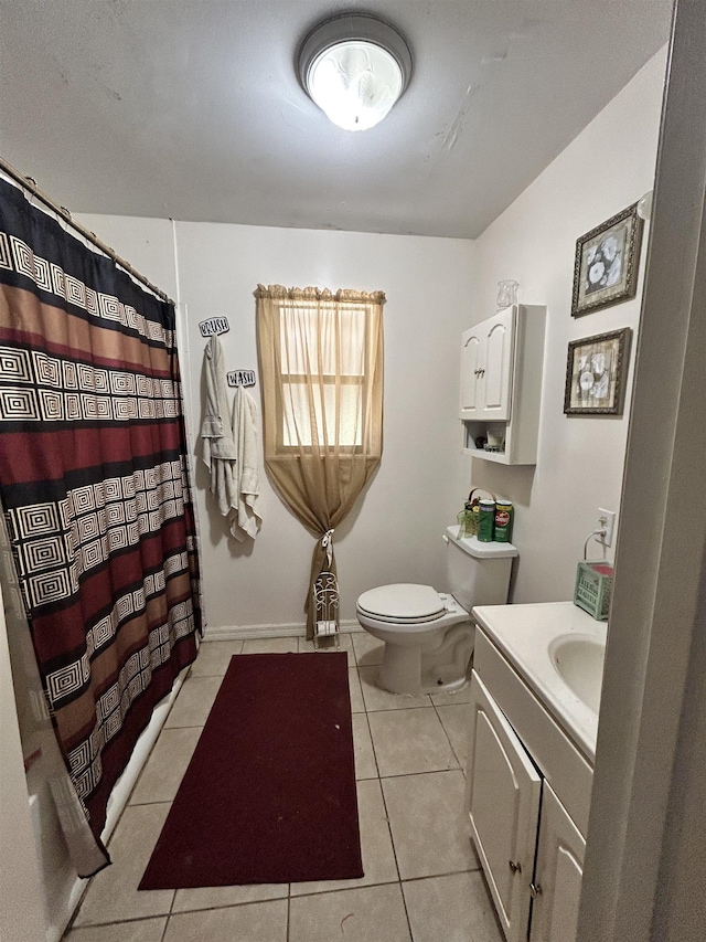 bathroom with tile patterned flooring, vanity, and toilet