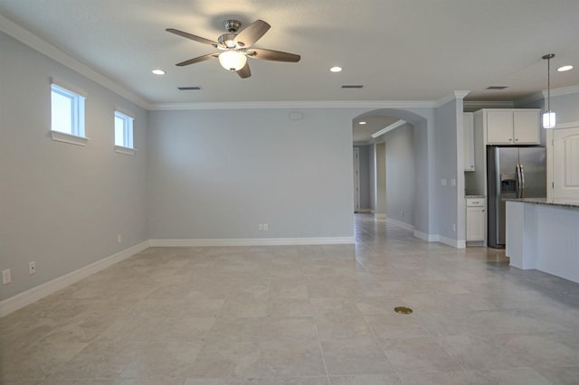 unfurnished living room with ceiling fan and ornamental molding