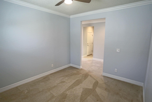 carpeted spare room featuring ceiling fan and ornamental molding