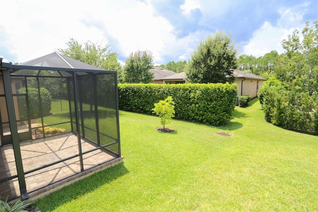 view of yard featuring glass enclosure