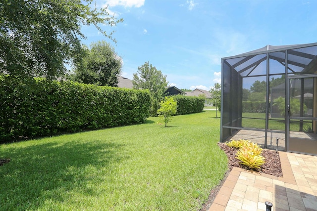 view of yard featuring glass enclosure