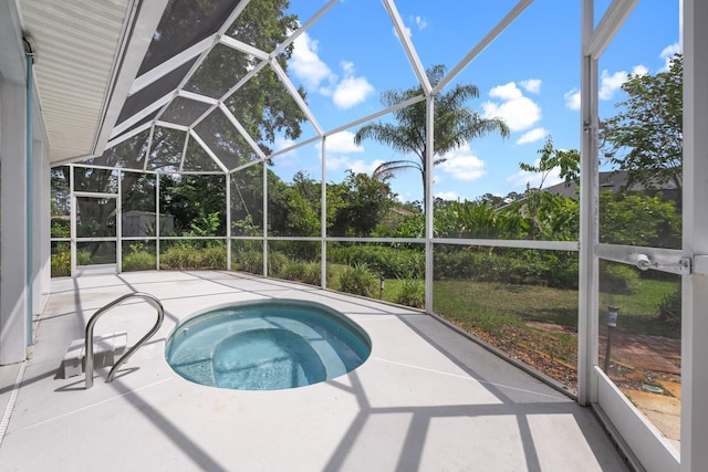 view of swimming pool with a lanai, a patio area, and an in ground hot tub