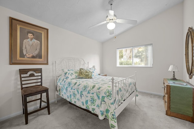 bedroom featuring vaulted ceiling, ceiling fan, light carpet, and baseboards