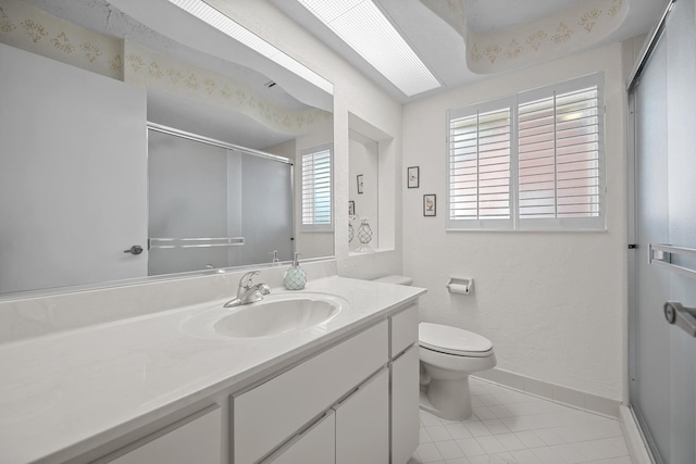 bathroom featuring tile patterned flooring, toilet, vanity, baseboards, and a shower stall