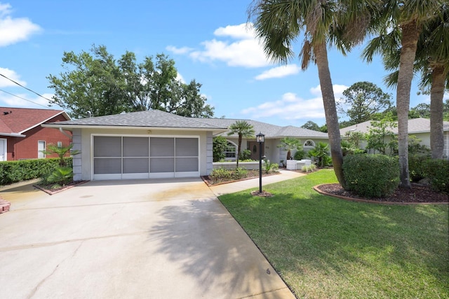 single story home featuring concrete driveway, a front lawn, an attached garage, and stucco siding