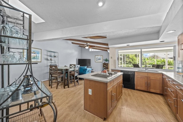 kitchen with brown cabinetry, black dishwasher, light countertops, and a kitchen island