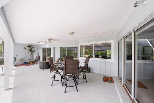 sunroom featuring a ceiling fan