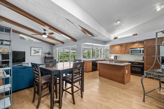 dining area with vaulted ceiling with beams, light wood finished floors, a textured ceiling, and recessed lighting