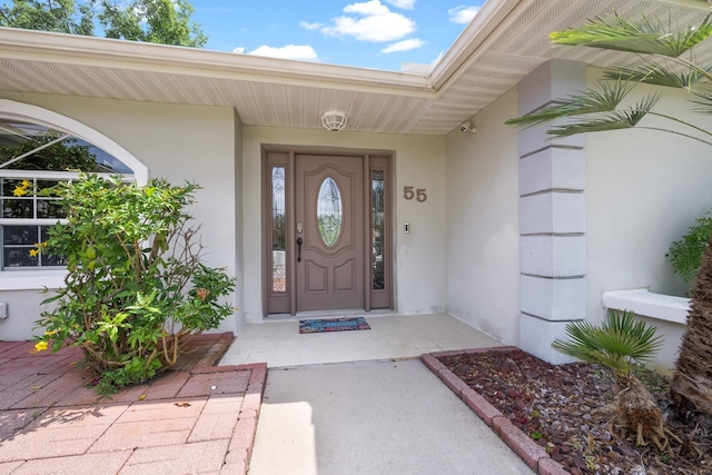 entrance to property featuring stucco siding