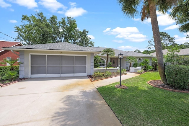 view of front of property with a garage, driveway, a front yard, and stucco siding