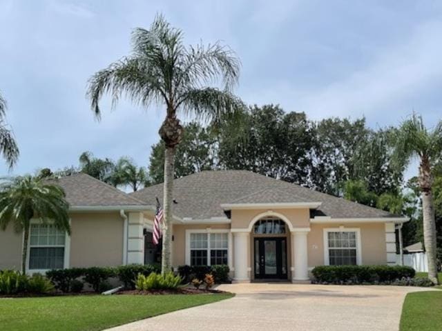 ranch-style home with a front yard