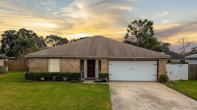 ranch-style house featuring a lawn and a garage