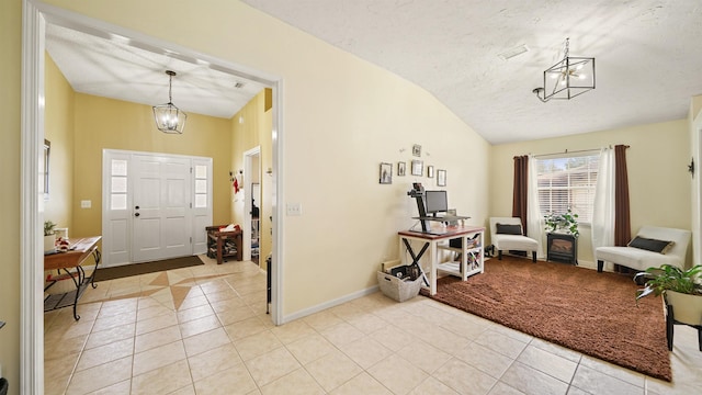 entryway featuring light tile patterned floors, a textured ceiling, and lofted ceiling