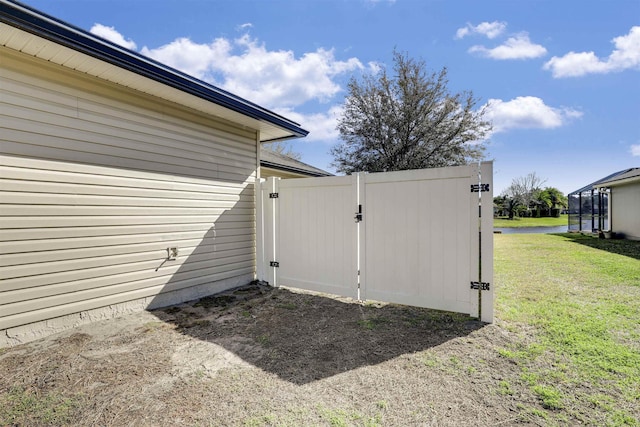 view of outbuilding featuring a gate and fence