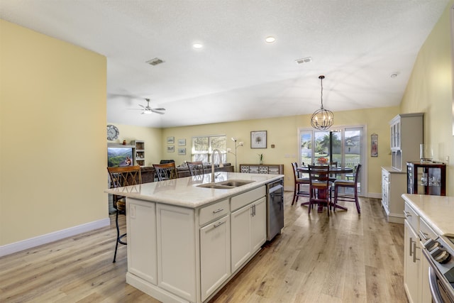 kitchen featuring dishwasher, plenty of natural light, a sink, and visible vents