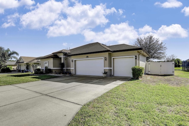 view of front of home featuring concrete driveway, a front yard, an attached garage, and stucco siding