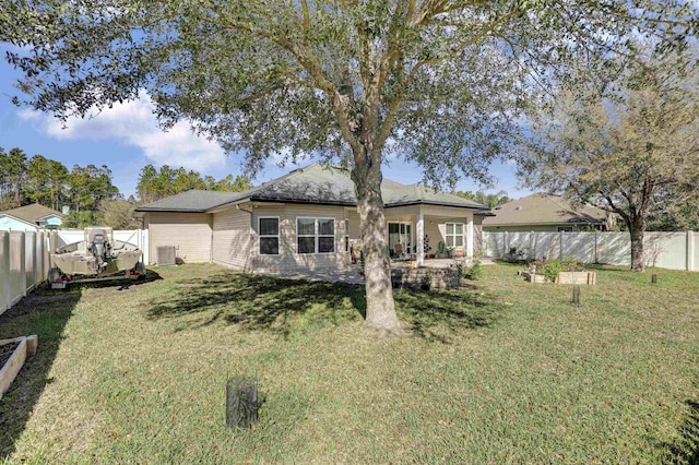 back of property with cooling unit, a patio area, a fenced backyard, and a yard