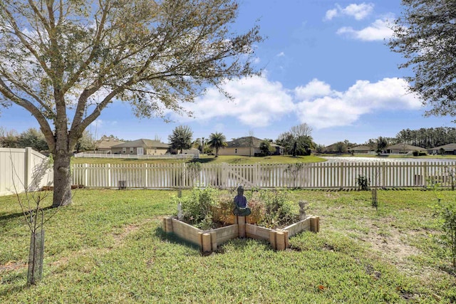 view of yard with a fenced backyard and a garden