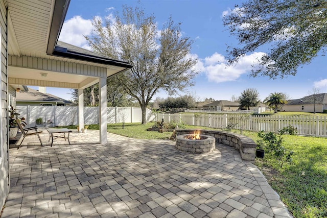 view of patio with an outdoor fire pit and a fenced backyard