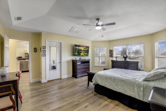 bedroom featuring baseboards, visible vents, a ceiling fan, a textured ceiling, and light wood-type flooring