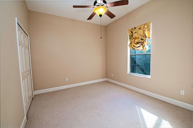 empty room featuring carpet floors and ceiling fan