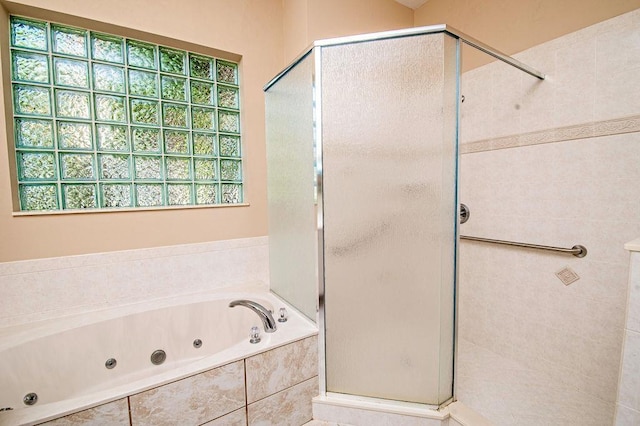 bathroom with separate shower and tub and plenty of natural light