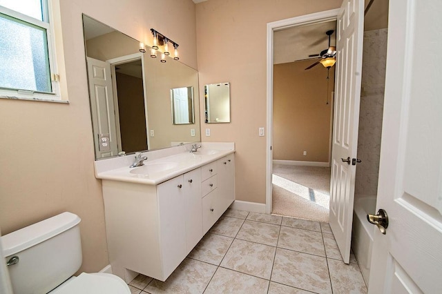 bathroom with tile patterned floors, vanity, toilet, and ceiling fan