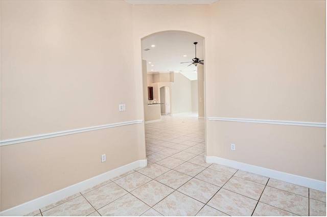 tiled empty room featuring ceiling fan