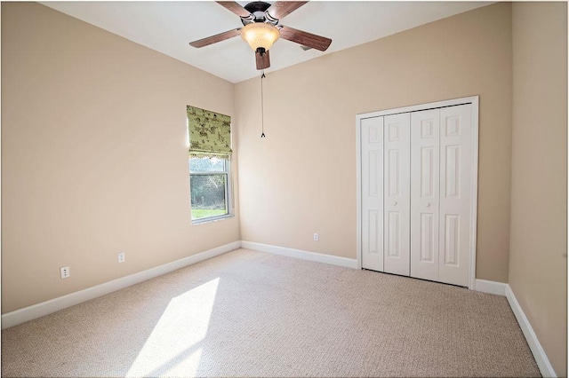 unfurnished bedroom with carpet, a closet, and ceiling fan