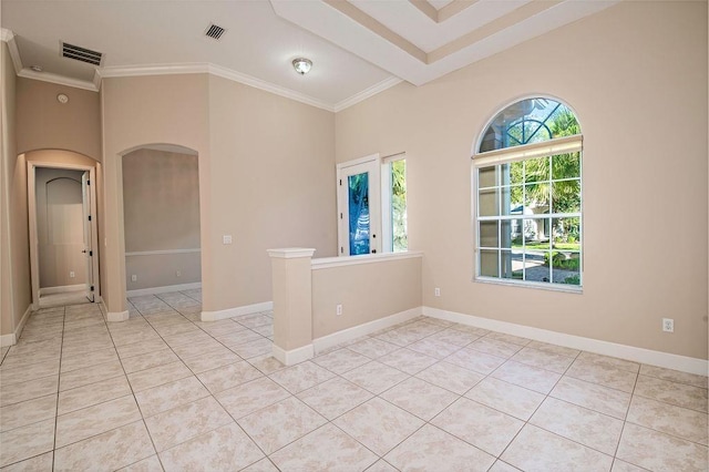 tiled empty room with beam ceiling and crown molding