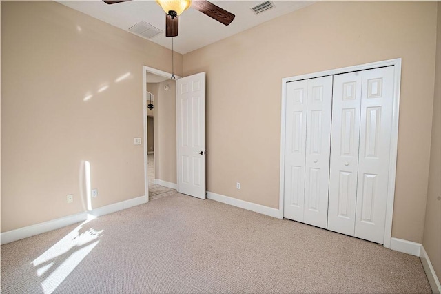 unfurnished bedroom featuring carpet flooring, a closet, and ceiling fan