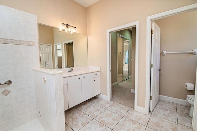 bathroom featuring tile patterned floors, vanity, and toilet