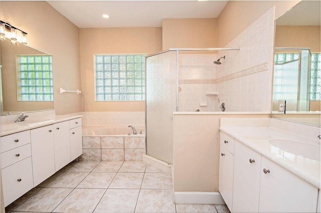 bathroom with shower with separate bathtub, vanity, and a healthy amount of sunlight