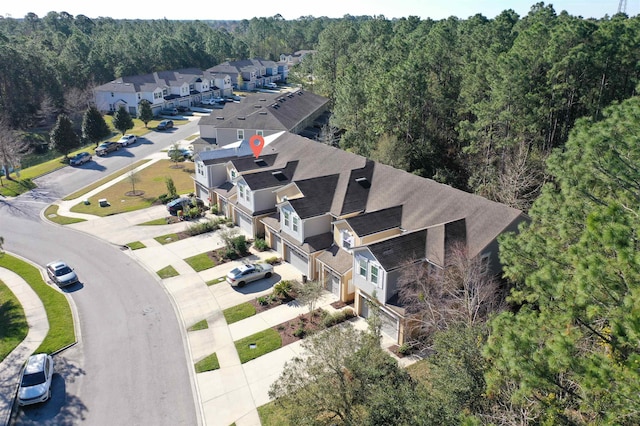 bird's eye view featuring a residential view and a view of trees