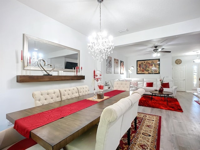 dining room with ceiling fan, visible vents, and wood finished floors