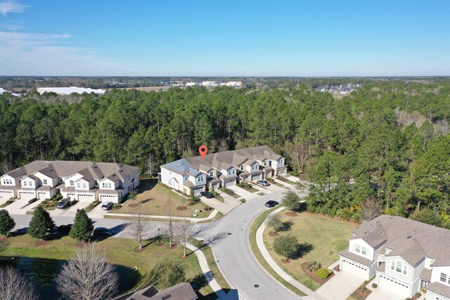 bird's eye view featuring a residential view and a wooded view