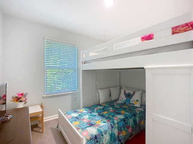 bedroom featuring light wood-style floors and baseboards