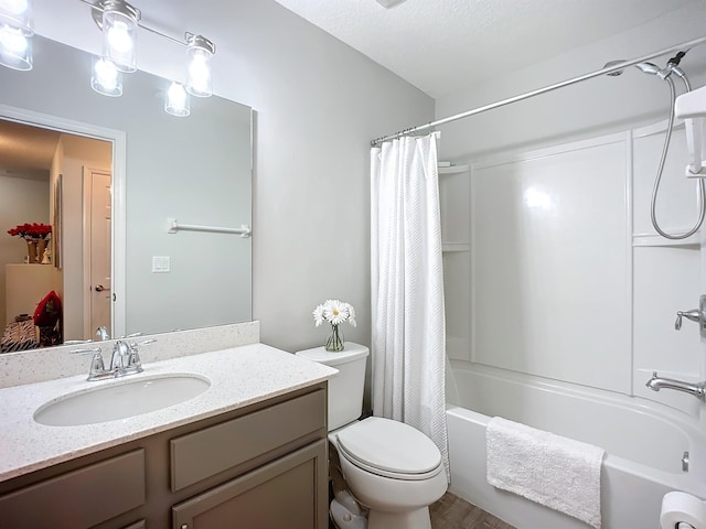 full bathroom featuring toilet, shower / tub combo with curtain, and vanity