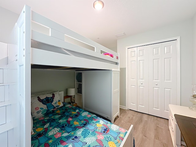 bedroom featuring a closet and light wood-style flooring