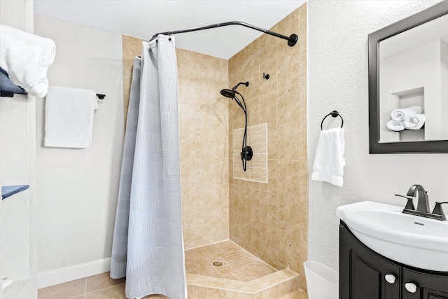 bathroom with a shower with curtain, vanity, and tile patterned floors