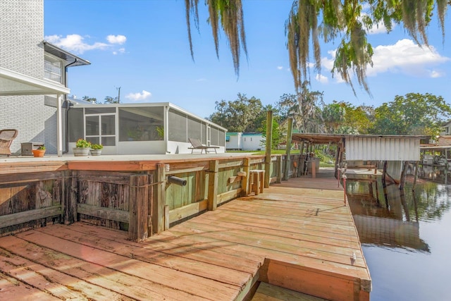 wooden terrace featuring a sunroom and a water view