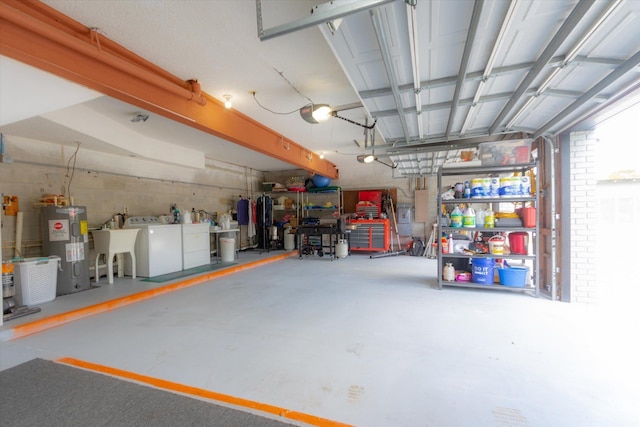 garage featuring sink, electric water heater, a garage door opener, and washing machine and clothes dryer