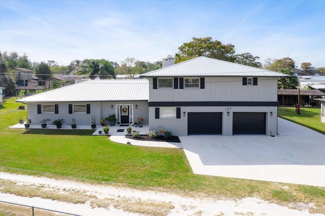 view of front of property with a garage and a front lawn