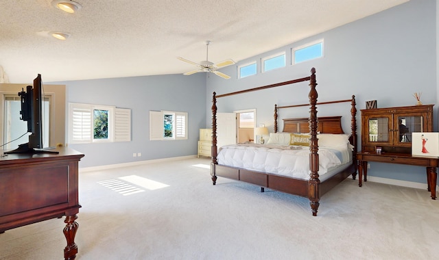 bedroom featuring light carpet, a textured ceiling, and baseboards